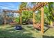 Peaceful backyard with pergola, fire pit, and wooden swings at 118 24Th W St, Bradenton, FL 34205