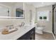 Modern bathroom with navy vanity and herringbone tile floors at 118 24Th W St, Bradenton, FL 34205