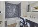 Bathroom boasts a herringbone tile shower and updated vanity at 118 24Th W St, Bradenton, FL 34205
