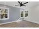 Charming bedroom with shiplap wall, wood-look floors, and multiple windows at 118 24Th W St, Bradenton, FL 34205