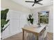Light-filled dining area with wood table and white chairs at 118 24Th W St, Bradenton, FL 34205
