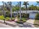 Charming single story home with a brick walkway, lush landscaping, and a two-car garage at 118 24Th W St, Bradenton, FL 34205