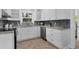 Modern kitchen featuring white shaker cabinets and herringbone floors at 118 24Th W St, Bradenton, FL 34205