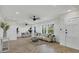 Bright living room with herringbone floors, white wainscoting, and neutral decor at 118 24Th W St, Bradenton, FL 34205