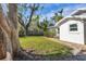Landscaped side yard with mature trees and gravel pathway at 118 24Th W St, Bradenton, FL 34205