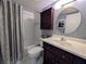 Clean bathroom with tub, shower, vanity, and linen storage at 1310 Glen Oaks E Dr # 290E, Sarasota, FL 34232