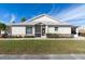 Front view of villa showing entryway, landscaping, and screened porch at 1702 Fairway Trce # 1702, Palmetto, FL 34221