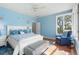 Comfortable bedroom with bright blue walls and wood floors, featuring ample natural light at 2115 Lychee Ln, Nokomis, FL 34275