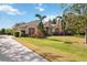 House exterior showcasing a driveway and lush landscaping at 22435 Panther Loop, Bradenton, FL 34202
