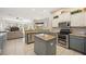 Open concept kitchen with large island and stainless steel appliances at 22435 Panther Loop, Bradenton, FL 34202