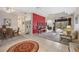 Open living and dining space with neutral carpet and red accent wall at 22435 Panther Loop, Bradenton, FL 34202