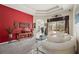 Living room with a red accent wall and access to the pool area at 22435 Panther Loop, Bradenton, FL 34202