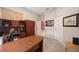 Home office with wooden desk and built-in shelving at 22435 Panther Loop, Bradenton, FL 34202