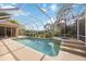 Inviting screened pool with spa and lush landscaping at 22435 Panther Loop, Bradenton, FL 34202