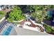 An aerial view of a backyard highlighting a patio, lush landscaping, and water feature at 2426 Nassau St, Sarasota, FL 34231