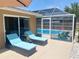 Relaxing poolside with chaise lounges near the screened-in pool enclosure at 2426 Nassau St, Sarasota, FL 34231