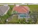 Aerial view of a house with a pool and neighborhood at 25324 Alicante Dr, Punta Gorda, FL 33955