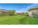 Large grassy backyard with mature trees and privacy hedges at 2886 Grazeland Dr, Sarasota, FL 34240