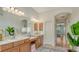 Bright bathroom features double sinks, vanity lighting, and great view to Primary bedroom at 2886 Grazeland Dr, Sarasota, FL 34240