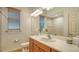 Clean bathroom with wood cabinets, single sink, and a large mirror at 2886 Grazeland Dr, Sarasota, FL 34240