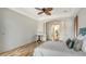 Spacious bedroom with wood floors, ceiling fan, and access to the bathroom at 2886 Grazeland Dr, Sarasota, FL 34240