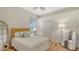 Cozy bedroom with a full bed, wood flooring, and decorative pillows, mirror and large window at 2886 Grazeland Dr, Sarasota, FL 34240