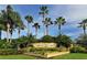 Welcome to Laurel Lakes! Scenic community entrance sign surrounded by beautiful landscaping and palm trees at 2886 Grazeland Dr, Sarasota, FL 34240