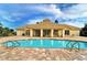 Inviting community pool with adjacent clubhouse and ample seating at 2886 Grazeland Dr, Sarasota, FL 34240