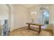 Dining room with chandelier, window, decorative vase, tile flooring and a wood table at 2886 Grazeland Dr, Sarasota, FL 34240