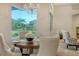 Charming dining room with a round table and chairs, overlooking the backyard at 2886 Grazeland Dr, Sarasota, FL 34240