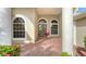 Elegant entryway with arched windows and double doors leading into the home at 2886 Grazeland Dr, Sarasota, FL 34240
