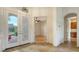 Bright foyer features tile flooring, and glass front doors allowing natural light to fill the home at 2886 Grazeland Dr, Sarasota, FL 34240