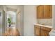 Light hallway with wood floors, built-in cabinets, and a view of the bathroom at 2886 Grazeland Dr, Sarasota, FL 34240