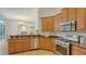 Modern kitchen with stainless steel appliances, granite countertops, and wood cabinetry at 2886 Grazeland Dr, Sarasota, FL 34240