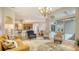 Bright living room features a comfy couch and two armchairs, opening to a view of the backyard at 2886 Grazeland Dr, Sarasota, FL 34240
