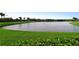 Scenic water view of a pond surrounded by manicured lawns and green foliage at 2886 Grazeland Dr, Sarasota, FL 34240