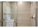 Walk-in shower with glass enclosure and neutral tile at 2886 Grazeland Dr, Sarasota, FL 34240