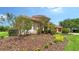 Well-maintained side yard with lush landscaping and beautiful flowering trees at 2886 Grazeland Dr, Sarasota, FL 34240