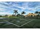 Community tennis court with surrounding landscape and clubhouse view at 2886 Grazeland Dr, Sarasota, FL 34240