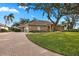 Brick house with a large yard and driveway at 2957 Wilderness E Blvd, Parrish, FL 34219