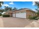 Brick house exterior with three car garage at 2957 Wilderness E Blvd, Parrish, FL 34219
