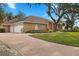 Brick home with three-car garage and paver driveway at 2957 Wilderness E Blvd, Parrish, FL 34219