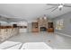 Open kitchen and living area with a brick breakfast bar and fireplace at 2957 Wilderness E Blvd, Parrish, FL 34219