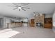 Open living room with kitchen, fireplace, and high ceilings at 2957 Wilderness E Blvd, Parrish, FL 34219