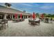 Outdoor patio area with tables, chairs, and umbrellas at 2957 Wilderness E Blvd, Parrish, FL 34219