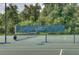 Clean tennis court with a net and boundary lines at 2957 Wilderness E Blvd, Parrish, FL 34219