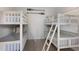Charming bedroom with twin-size bunk beds, perfect for guests at 307 Spring Ave, Anna Maria, FL 34216