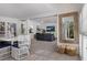 Bright dining area with white table and chairs, open to the living room at 307 Spring Ave, Anna Maria, FL 34216