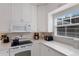 Well-equipped kitchen featuring white cabinetry and quartz countertops at 307 Spring Ave, Anna Maria, FL 34216