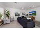 Spacious living room with dark gray sectional sofa and large TV at 307 Spring Ave, Anna Maria, FL 34216
